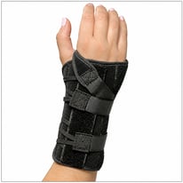 Hand wearing a black Choice Wrist Brace for wrist support and immobilization.